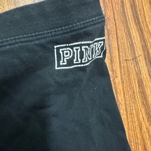 black leggings from pink with pink logo and two white stripes on each side